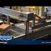 conventional-palletizer-APL-5240-video-2-splashimage Conventional case palletizer - boxes on conveyor