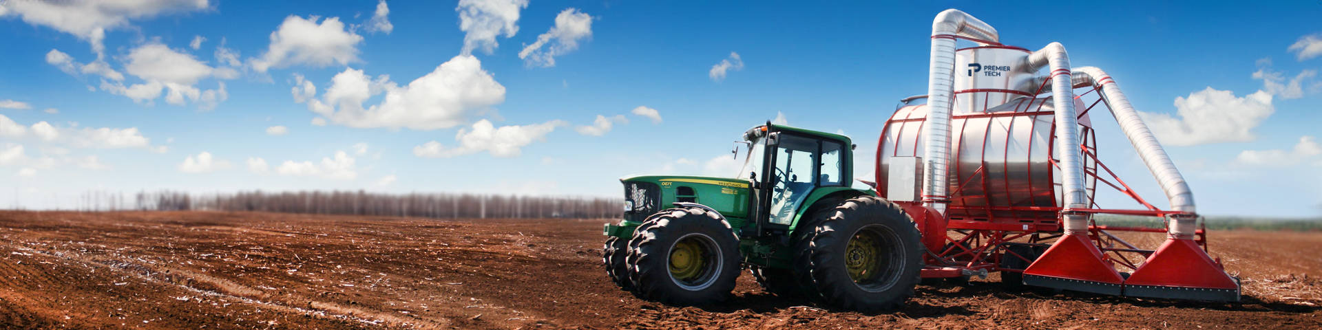 Tractor pulling a two-head vacuum peat harvester